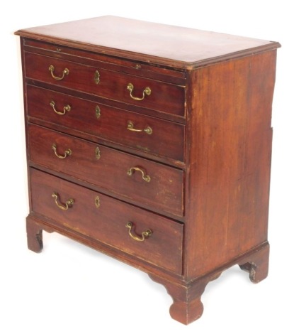 A George III mahogany chest of drawers, with arrangement of a slide and four long drawers, with brass swing handles and escuteons, on bracket feet, 82cm high, 81cm wide, 44cm deep.