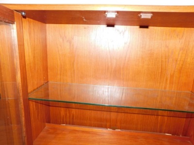 A teak G-Plan corner suite, comprising cabinets, bookshelves and sideboard, in arrangement of four pieces, 200cm high, two base unit 163cm wide. (6 pieces) WARNING! This lot contains untested or unsafe electrical items. It is supplied for scrap or re-con - 2