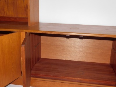 A teak G-Plan corner suite, comprising cabinets, bookshelves and sideboard, in arrangement of four pieces, 200cm high, two base unit 163cm wide. (6 pieces) WARNING! This lot contains untested or unsafe electrical items. It is supplied for scrap or re-con - 3