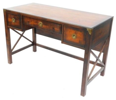 A hardwood writing desk or dressing table, with an arrangement of two drawers with circular brass handles, on X framed supports, 78cm high, 120cm wide, 56cm deep, retailed by Laura Ashley.