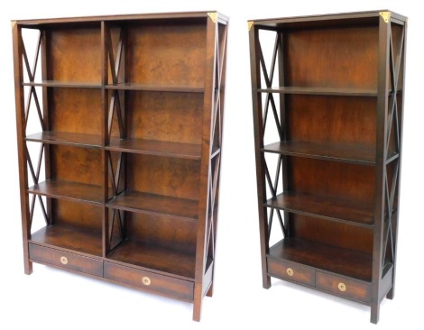 A hardwood bookcase, formed as two parts with a single and double section, with shaped sides and two drawer base, 176.5cm high, 88.5cm wide, 34cm deep, the double section 130cm wide, retailed by Laura Ashley. (2)