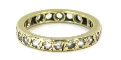 An eternity ring, set with imitation diamonds, in a white metal setting, unmarked, size M.