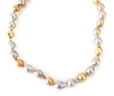 A pearl necklace, with multi coloured natural pearl links, in a cream, orange and grey overall lustre, the beads approximately 1.5cm high on a yellow metal clasp with expansion clasp, stamped 10kt, 53.8g all in.