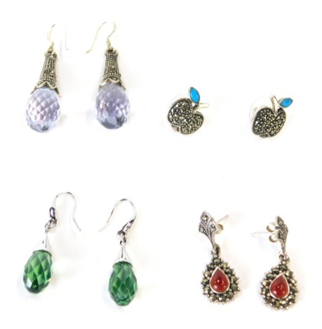 Four pairs of silver and stone set earrings, to include a pair of marcasite and turquoise set apple studs, a pair of agate and marcasite set hoops, and a pair of green crystal drop earrings with silver top mount together with a pair of purple crystal ball