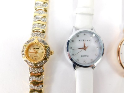 A group of lady's wristwatches, to include a Skagen chronograph on white leather strap, a Skagen stainless and red material strapped bracelet, a Skagen gold plated and mother of pearl dial wristwatch, an Aurora lady's wristwatch and a Paulo Fude wristwatc - 2