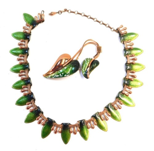 Two items of Matisse enamel jewellery, comprising a brass and green enamel leaf graduated necklace, 36cm long, and a two strand leaf brooch, 8cm high. (2)