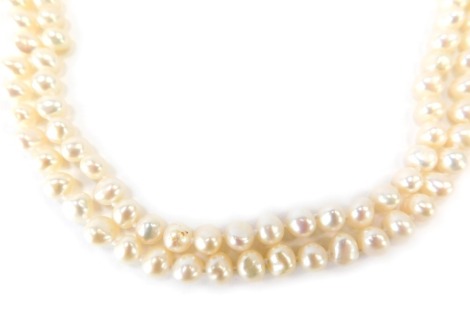 A two row and twist design pearl necklace, with white lustre finish on a string strand with yellow metal clasp, stamped 10kt, 51cm long, 74.6g all in.