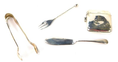 A George V silver vesta case, Birmingham 1943, bearing the initials JAC, a silver butter knife, a pair of Victorian silver shell capped sugar tongs, and a silver pickle fork with twist stem and bobble end, 2¼oz. (4)