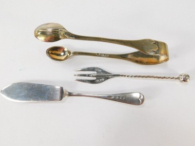 A George V silver vesta case, Birmingham 1943, bearing the initials JAC, a silver butter knife, a pair of Victorian silver shell capped sugar tongs, and a silver pickle fork with twist stem and bobble end, 2¼oz. (4) - 3