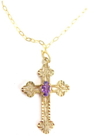 A 9ct gold crucifix pendant and chain, the crucifix set with oval amethyst in claw setting, on a fine link neck chain, the pendant, 4cm high, the chain 40cm long, 0.9g all in.