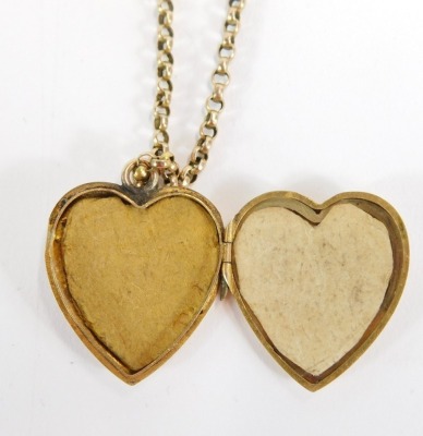 A 9ct gold heart shaped locket and chain, the heart shaped locket with vine detail, 3cm high, on a curb link neck chain with barrel clasp, 56cm long, 8.4g all in. - 2