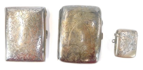 A George V silver cigarette case, with engraved borders and monograms, Birmingham 1917, another similar and a vesta case. (3)