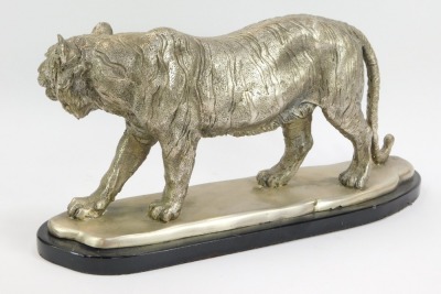 A polished metal model of a prowling tiger, on a mounted black oval base, 24cm high, 49cm, wide, 15cm deep. - 2