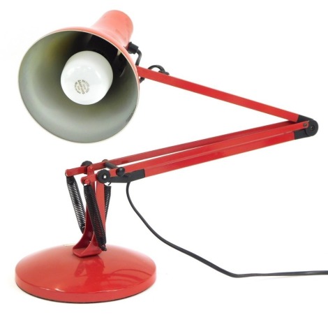 A red anglepoise desk lamp, 90cm high, fully extended.