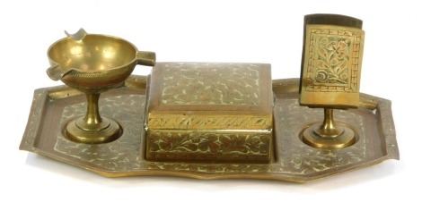 An Eastern brass desk stand, with central lidded box, bowl and stand, on an octagonal base, 11cm high, 23cm wide, 14cm deep.