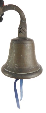 A brass bell, with wall mounting fitting, 21cm high.