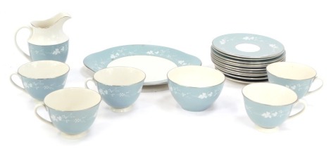 A Royal Doulton Reflections part tea service, on a blue ground with white vine flowers, comprising five cups, four saucers, six side plates, cake plate, milk jug and sugar bowl. (1 tray)