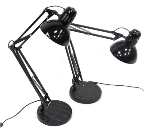 Two black anglepoise desk lamps, on circular base, 80cm high when fully extended.