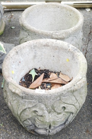 A pair of reconstituted stone planters, each with applied moulding, 45cm high, 42cm diameter.