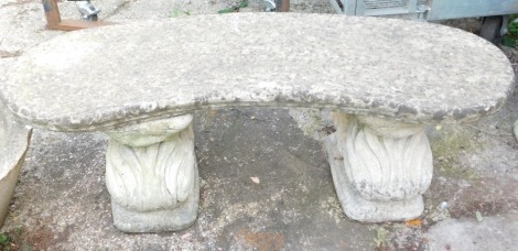 A reconstituted stone garden bench, the arch top of two squirrel supports, 42cm high, 118cm wide, 40cm deep.