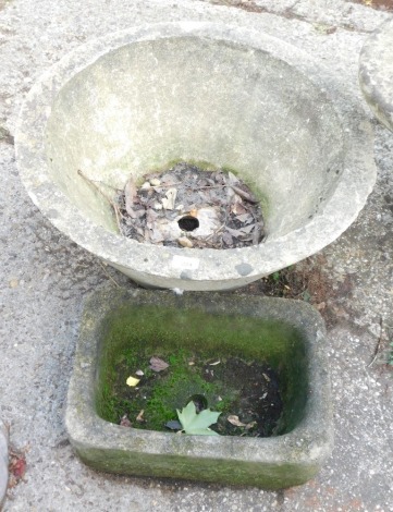 Two reconstituted stone planters, comprising a circular planter, 60cm high, and a rectangular stone hewn trough, 39cm wide. (2)