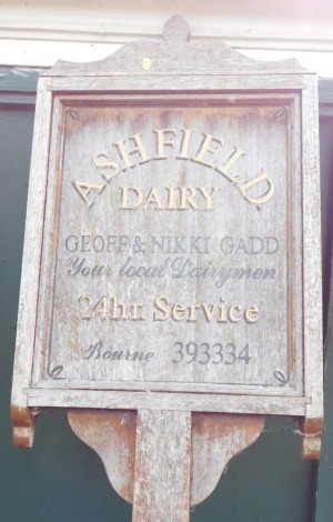 An Ashfield Dairy wooden advertising sign, Jeff and Nicky Gadd, Local Dairymen, 220cm high, 52cm wide, 9cm deep.