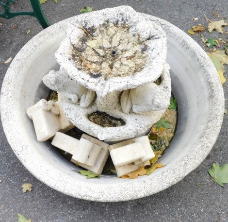 A reconstituted stone water fountain, with large oval base on two mounted tiers, with frogs, 60cm high, 80cm diameter. (AF)