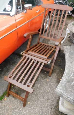 A teak garden lounger.