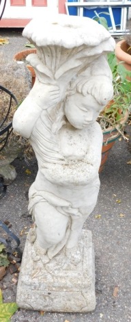 A reconstituted stone stand, formed as a boy carrying flower, 82cm high.