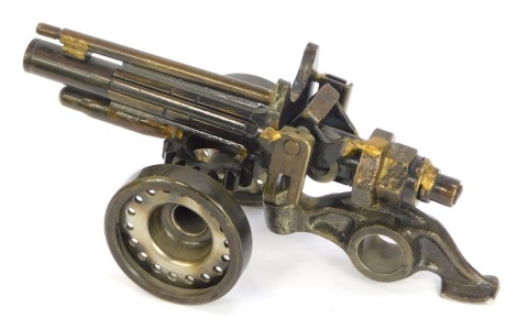 A novelty bolt cannon, formed of old cogs and bolts, 20cm wide.