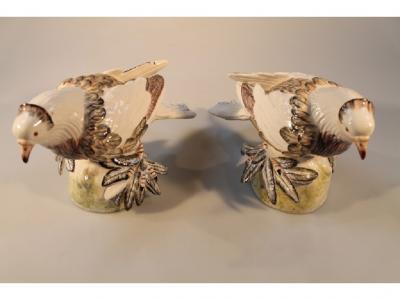 A pair of modern Italian pottery pigeons with polychrome detail on naturalistically