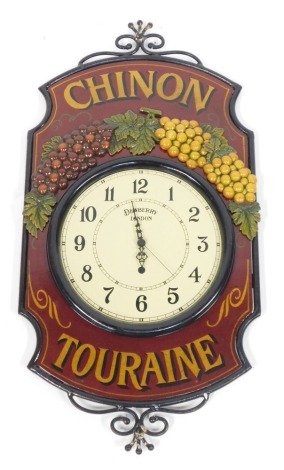 A Chinon Touraine Dewberry London wall clock, with raised relief moulded grape vines and wrought supports on a red ground, 78cm x 40cm.