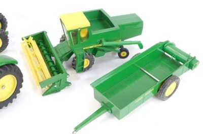 John Deere diecast agricultural vehicles, comprising spreader, toy combine, utility tractor with end loader and the Ertl Toys 5020 tractor, each boxed. (4) - 3