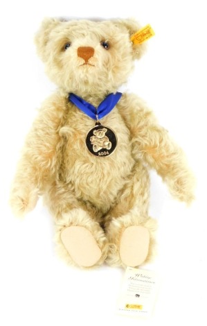 A blonde plush jointed 2004 edition Teddy bear, with labels, 31cm high.