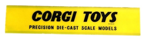 A Corgi Toys yellow advertising sign, The Precision The Diecast Scale Models, on a yellow background, 71cm x 15.5cm.