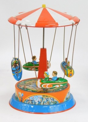 A group of tinplate toys, comprising a tinplate spinning ferris wheel, 20cm high, a fire truck, and a Japanese fire truck, boxed. (3) - 4