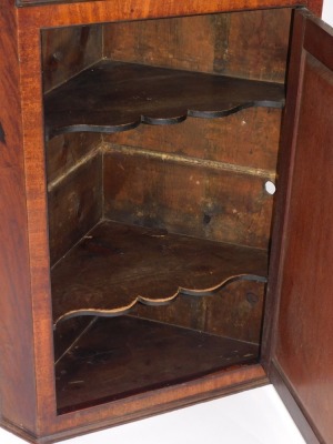 A 19thC mahogany corner cupboard, with moulded top and cross banded decoration and bone escuteon, 106cm high, 68cm wide, 48cm deep. - 2