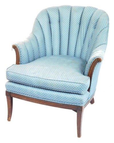 A mahogany armchair, with moulded back, in blue chequered upholstery, 85cm high, 80cm wide, 63cm deep. (AF) The upholstery in this lot does not comply with the 1988 (Fire & Fire Furnishing) Regulations, unless sold to a known exporter or upholsterer it w