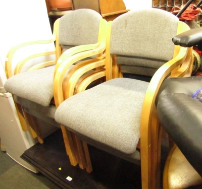 A set of six grey office chairs.