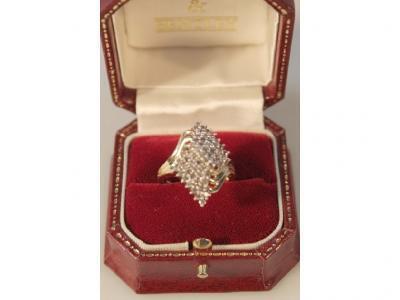 A lozenge shaped cluster diamond ring