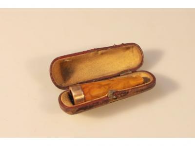 An amber cigar holder with 15ct gold band