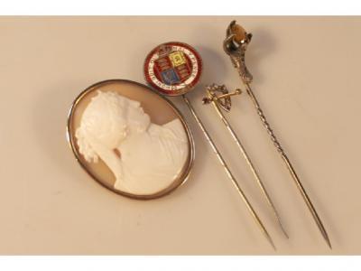 Three stick pins and a cameo brooch in yellow metal frame