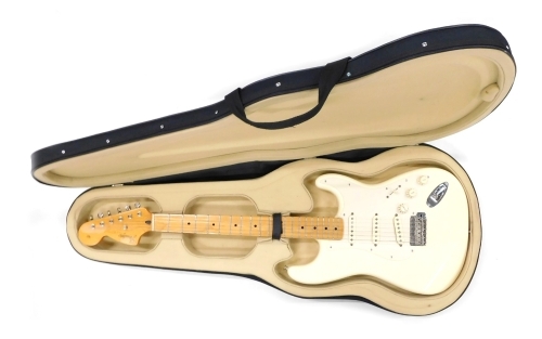 A Fender Stratocaster electric guitar, six string, in cream, no.MZ7010840, 100cm long, cased.