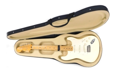 A Fender Stratocaster electric guitar, six string, in cream, no.MZ7010840, 100cm long, cased.