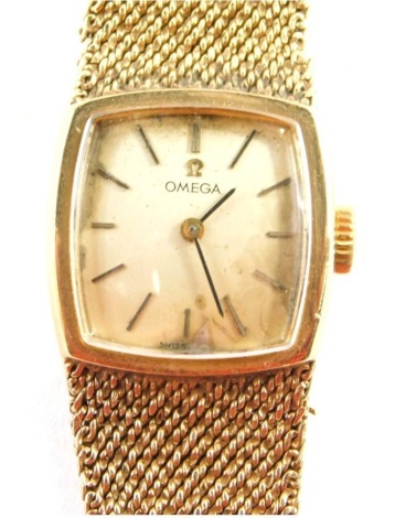 An Omega 9ct gold cased wristwatch, with a square curved set dial, on bark effect bracelet, the dial 2cm diameter, 19cm long, 34g all in, boxed with paperwork.