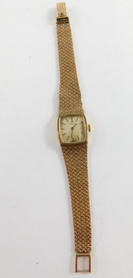 An Omega 9ct gold cased wristwatch, with a square curved set dial, on bark effect bracelet, the dial 2cm diameter, 19cm long, 34g all in, boxed with paperwork. - 2