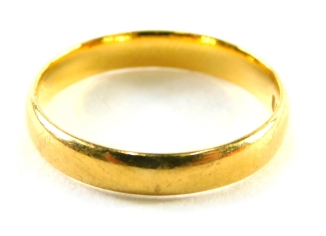 A 22ct gold wedding band of plain design, ring size L, 2.9g.