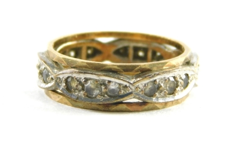 A diamond eternity ring, set with six marquise shaped panels, each set with three tiny diamonds, in a white metal setting with yellow metal outer border, marked 18, ring size J½, 3.7g all in.