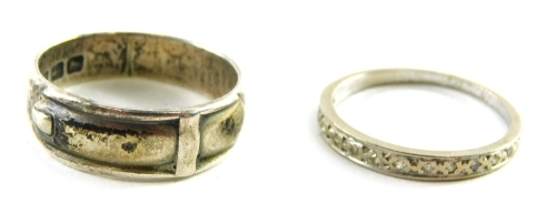 Two dress rings, comprising a silver buckle ring and an unmarked half hoop eternity ring, weighable silver 4g. (2)