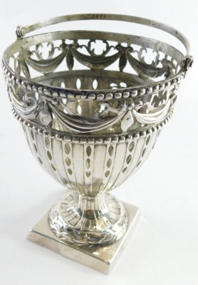 A George III silver plated Neo-Classical design basket, with swing handle, the body pierced with garlands and raised with orbs, on an inverted stem with square foot and blue glass liner, London 1774, maker AB, 3.14oz, 11cm high. - 3